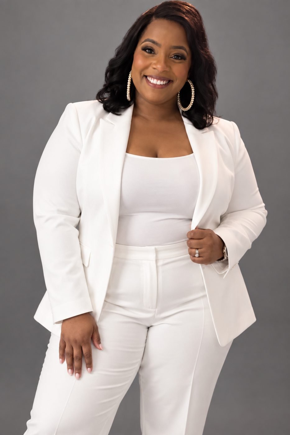 Johnnea Williams-McLeroy in a white suit, smiling